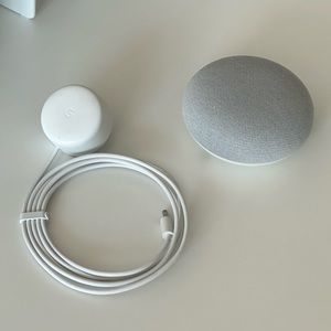 Google home white with a cord.